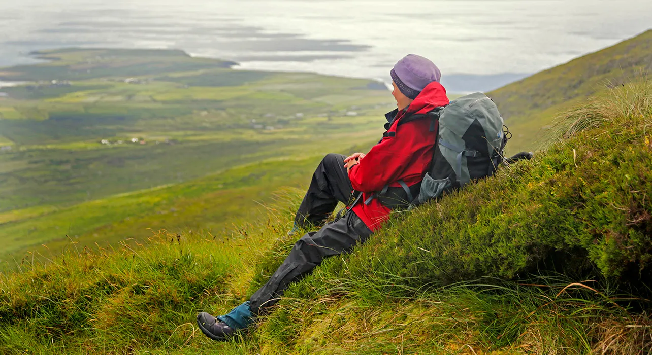 4-slide-ireland-mt-dingle-hiker-relaxing-pano - tours - travel