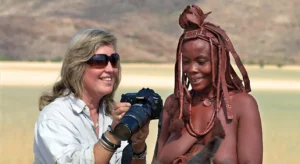 5-slide-himba-woman-camera-namibia-pano - tours - travel